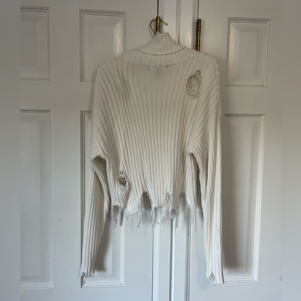Distressed white sweater